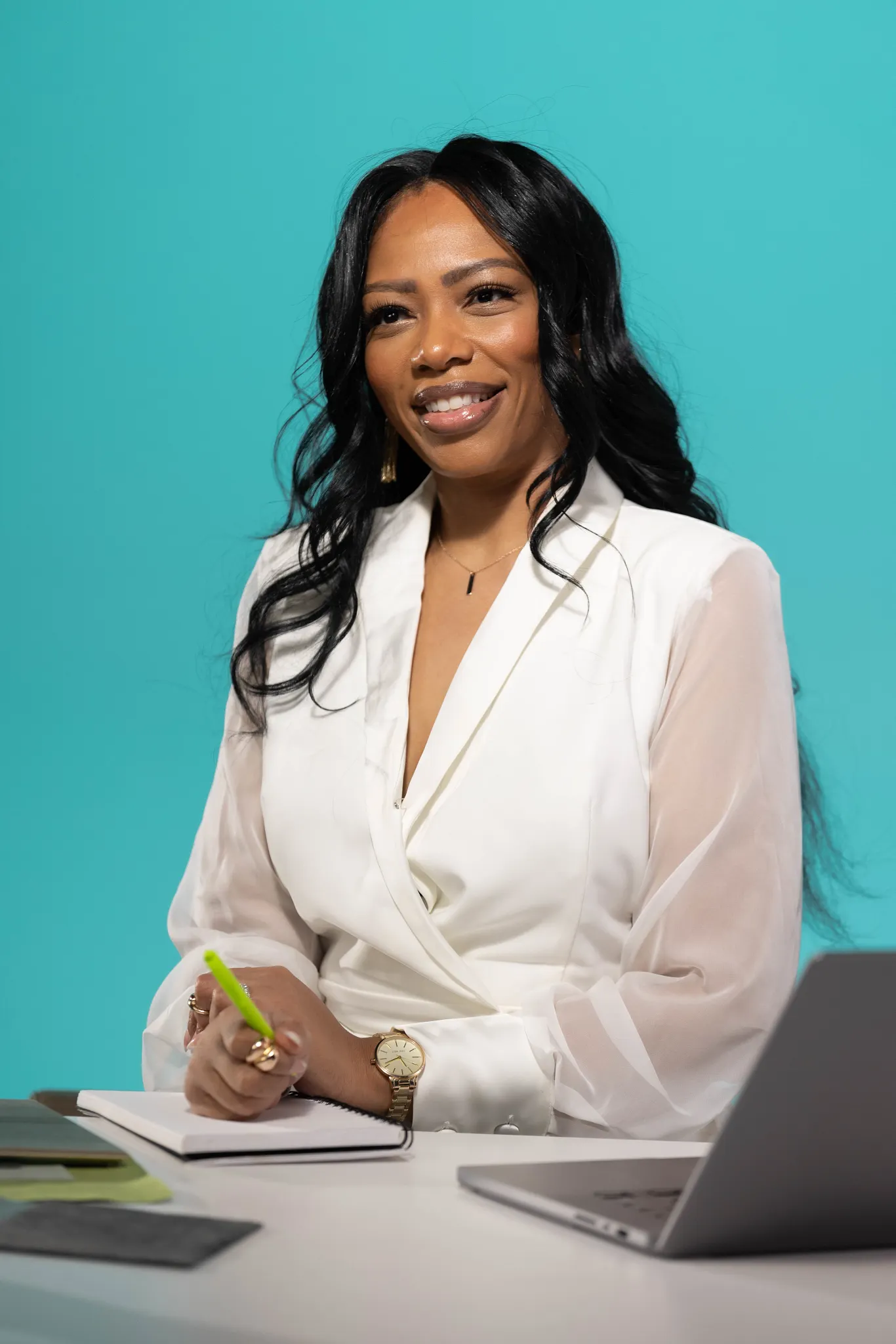 Professional woman in a black blazer standing outdoors with blurred background