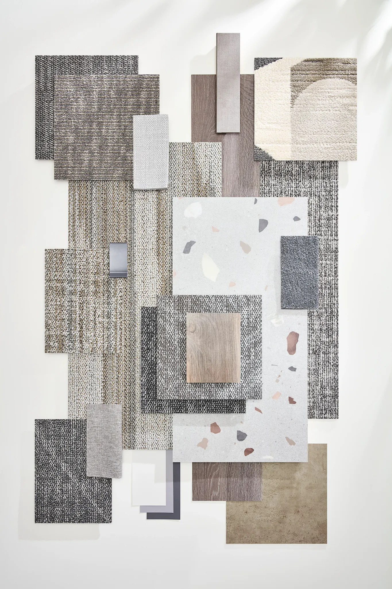 Assorted flooring swatches in neutral tones