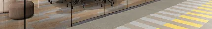 Durable LVT flooring for educational spaces, 48x7.75 inch Heavy commercial luxury vinyl tile in an education facility with yellow, grey, and beige stripes