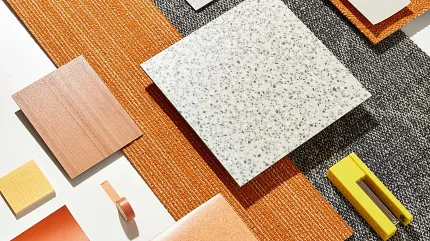 Diverse flooring options for modern interiors Assorted flooring swatches in orange, black, and grey