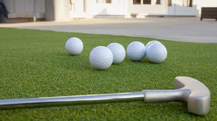 Perfect artificial grass for golf practice areas Golf balls and putter on artificial grass
