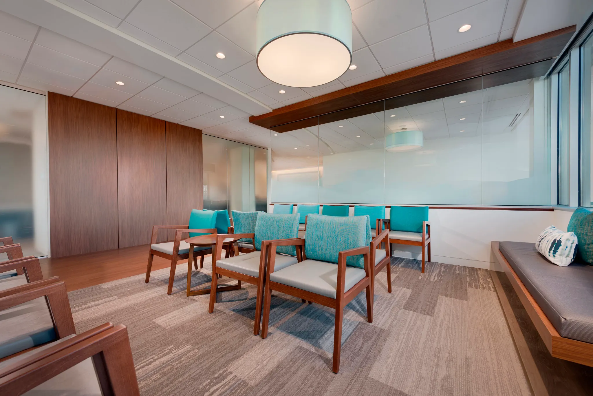 Healthcare facility waiting room with modern seating and commercial carpet tile flooring in neutral tones, 9x36 inch dimensions