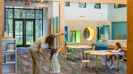 Education Facility with Commercial Carpet Tile Flooring and Wooden Beams Education facility with commercial carpet tile flooring in shades of blue and gray, featuring wooden beams and modern lighting