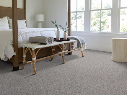 Neutral Carpet Flooring in Cozy Bedroom Scene Cozy bedroom with a four-poster bed and neutral carpet flooring
