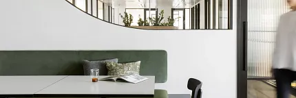 Contemporary Office Space with Elegant LVT Flooring Modern office hallway with sleek LVT flooring and glass door leading to a meeting room with a potted plant