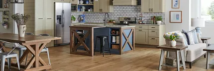 Engineered Hardwood Flooring in Modern Kitchen with Beige Cabinets and Stainless Steel Appliances kitchen with light wood engineered hardwood floor with beige cabinets stainless steel appliances and a dining area