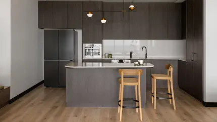 Contemporary Kitchen with Light Wood Flooring and Dark Cabinets Modern kitchen interior with light wood flooring, dark cabinetry, and minimalist design