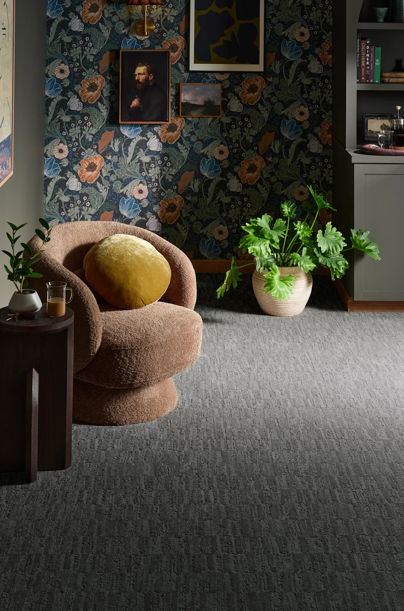 Elegant gray broadloom carpet in a stylish living room with a plush chair and vibrant plants