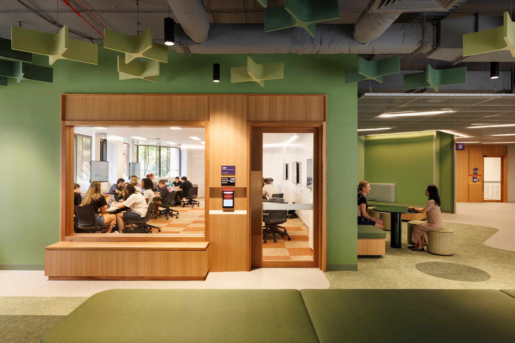 Modern higher education space with green and orange carpet flooring