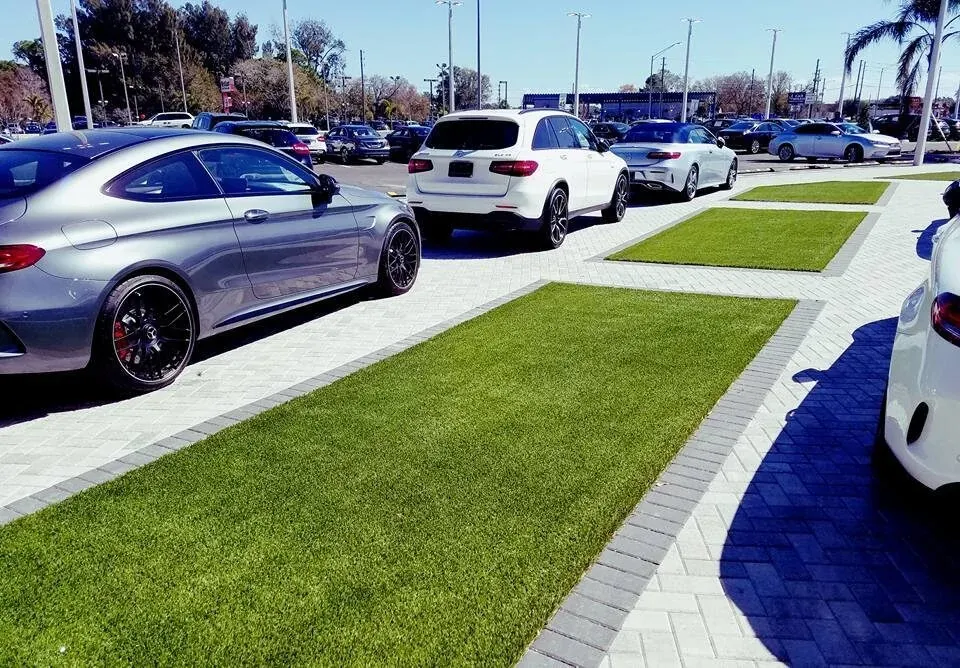 Cars parked on artificial grass and paver driveway