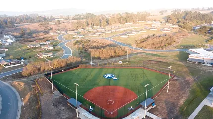 Baseball field with artificial turf in rural setting Aerial view of a baseball field with artificial turf surrounded by a rural landscape