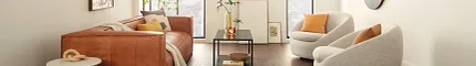 Contemporary Living Room with Wood Look Luxury Vinyl Plank Flooring. living room with dark wood look luxury vinyl plank floor with a brown leather sofa white round chairs and large windows
