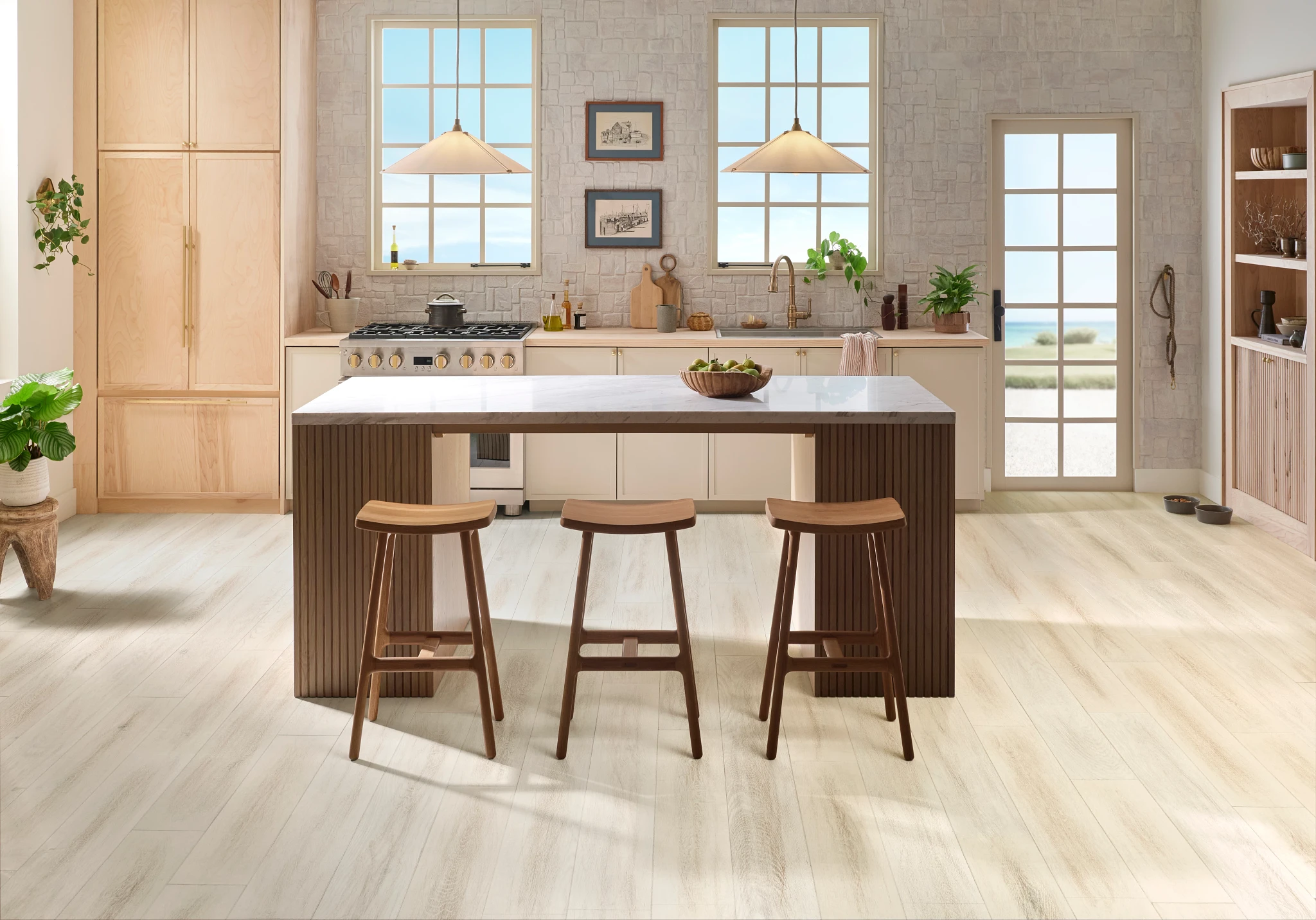 Modern kitchen with light hardwood flooring in a spacious room