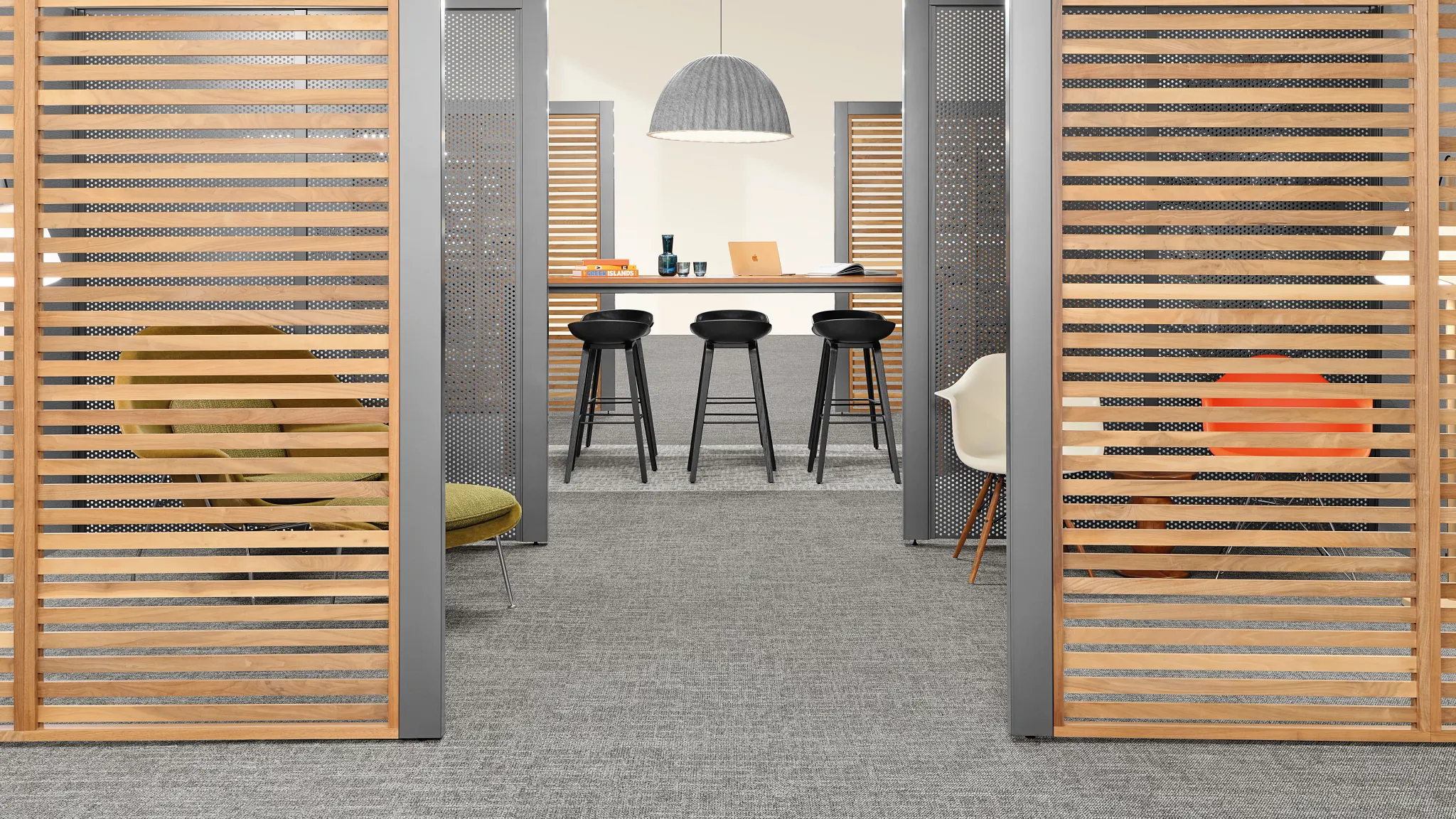 Community area with grey carpet tile and seating options