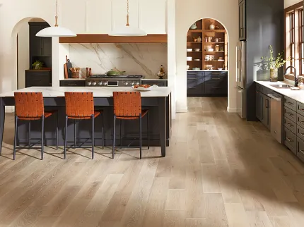 Light Brown Hardwood Flooring in Modern Kitchen Design Elegant kitchen with light brown hardwood flooring featuring wide planks in a modern home