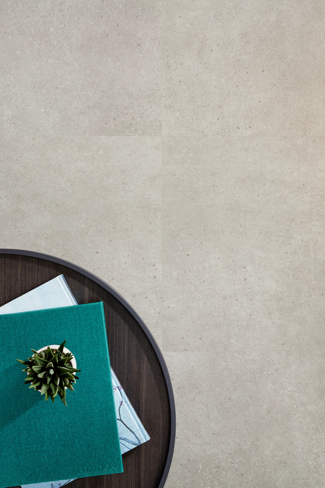 Commercial Luxury Vinyl Tile in neutral tones with a round table and books