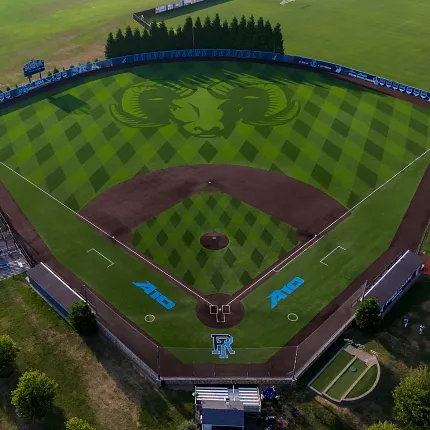 Baseball field with artificial turf and ram logo aerial view. Aerial view of a baseball field with artificial turf featuring a large ram logo in the center