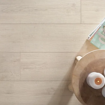 Light Wood-Look Flooring - Sound Core® Construction, 72.05x8.98 inch - Cozy and Durable. Light wood-look flooring with a natural finish, featuring a cozy setting with candles and reading glasses on a wooden table, 72.05x8.98 inch dimensions, Sound Core® construction, Direct Ship Internat