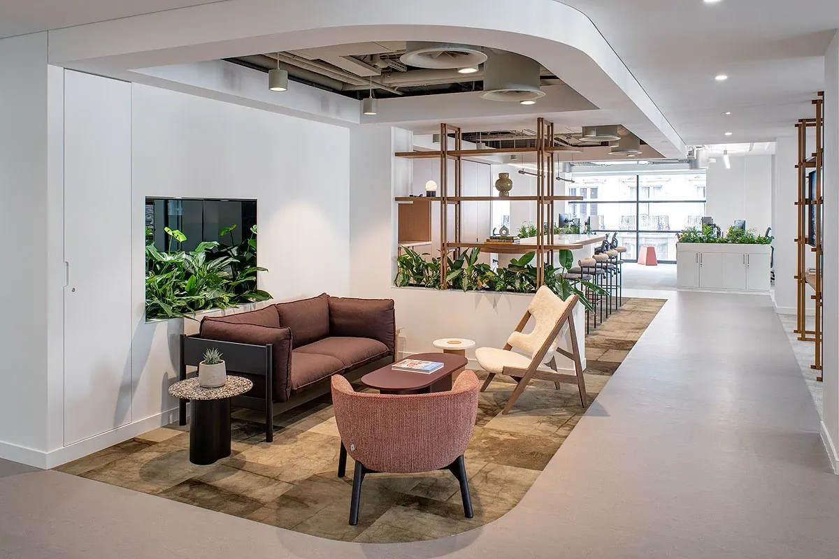 Modern office lounge with stylish seating and plants