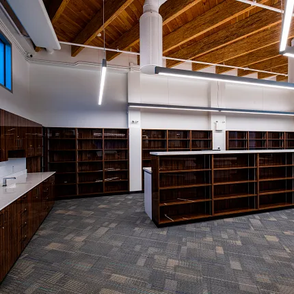 Retail space with commercial carpet tile and wooden ceiling design Modern retail space with wooden ceiling and commercial carpet tile flooring
