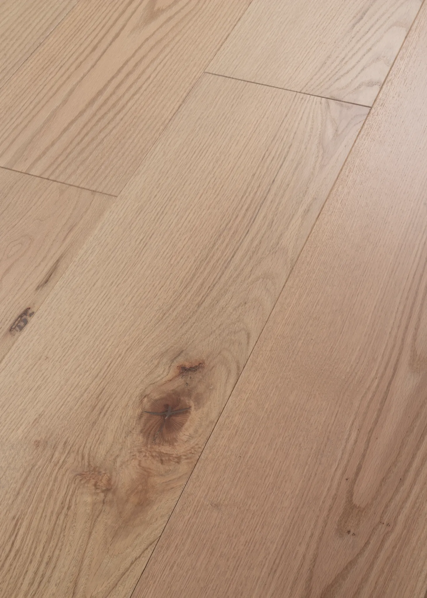 Light oak hardwood flooring with natural grain and knots