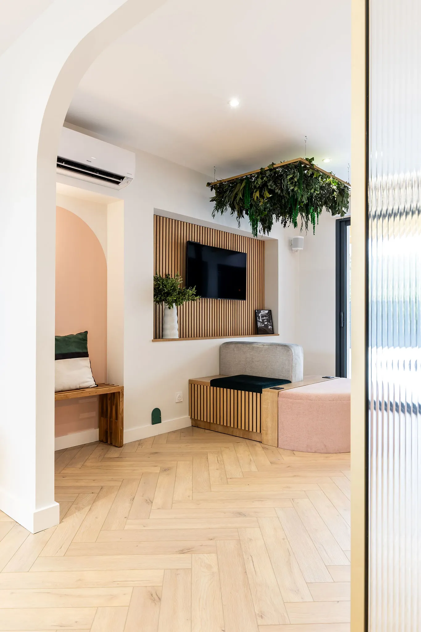 Modern living room with light wood herringbone flooring