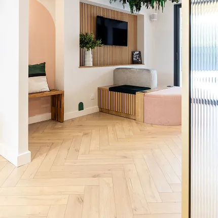 Modern living room with light wood herringbone flooring