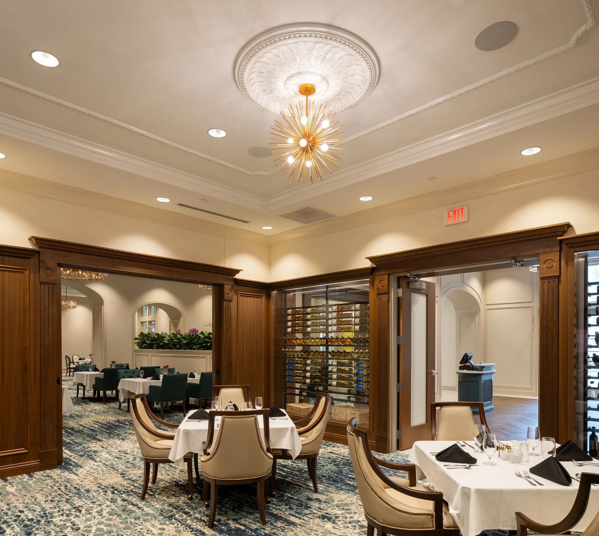 Elegant dining room with plush carpet and wooden accents