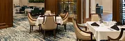 Luxurious carpet flooring in sophisticated dining setting Elegant dining room with plush carpet and wooden accents