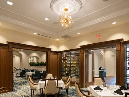 Luxurious carpet flooring in sophisticated dining setting Elegant dining room with plush carpet and wooden accents