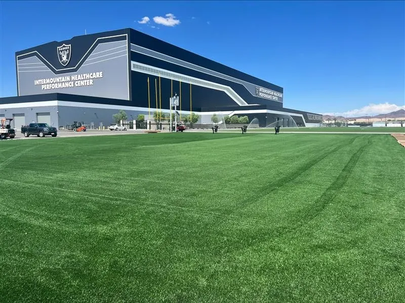 Artificial turf field outside Intermountain Healthcare Performance Center with clear blue sky