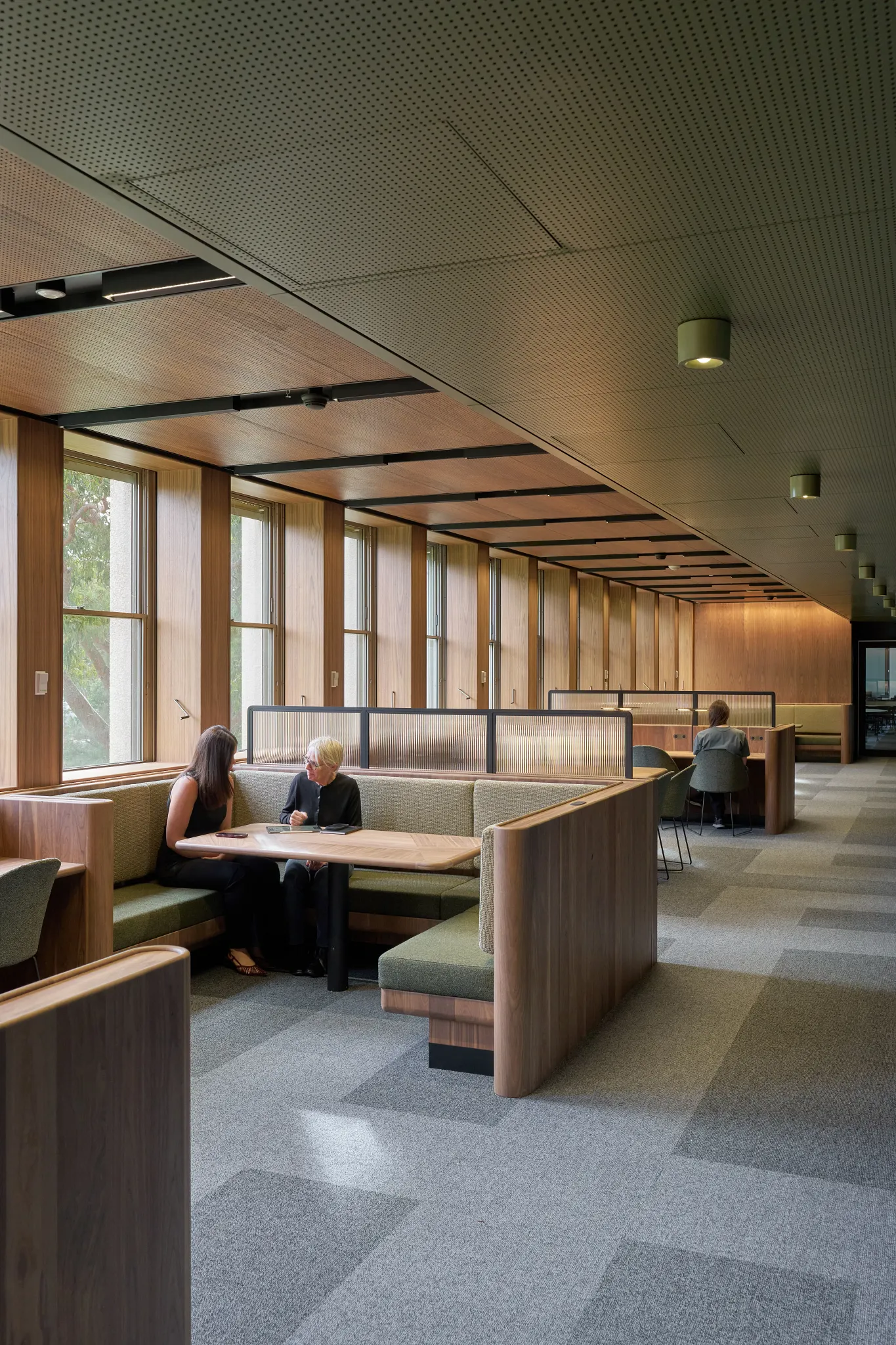 Study and collaboration area within the Monash University Clayton Menzies Building Level 1 Teaching Space Upgrades project by Hayball, featuring timber finishes, integrated booth seating and flexible learning spaces.