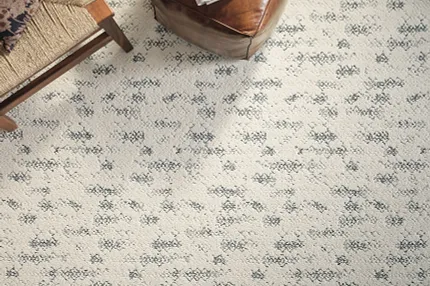 Premium Broadloom Carpet with Black and Gray Patterns - 12 ft Width Elegant broadloom carpet in a living room setting with intricate black and gray patterns on a cream background