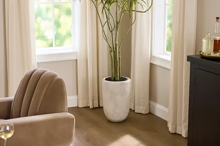 Stylish and durable vinyl flooring for modern living spaces Coretec Residential WPC vinyl flooring in a cozy living room with beige armchairs and a potted plant