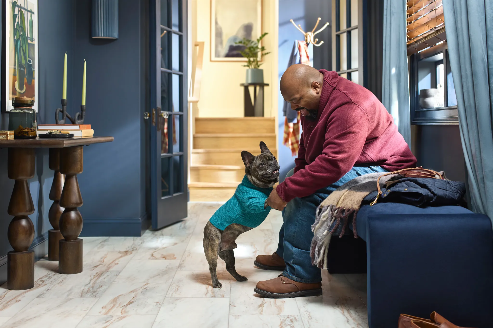 Coretec Residential WPC vinyl flooring in a cozy living room with a man and his dog