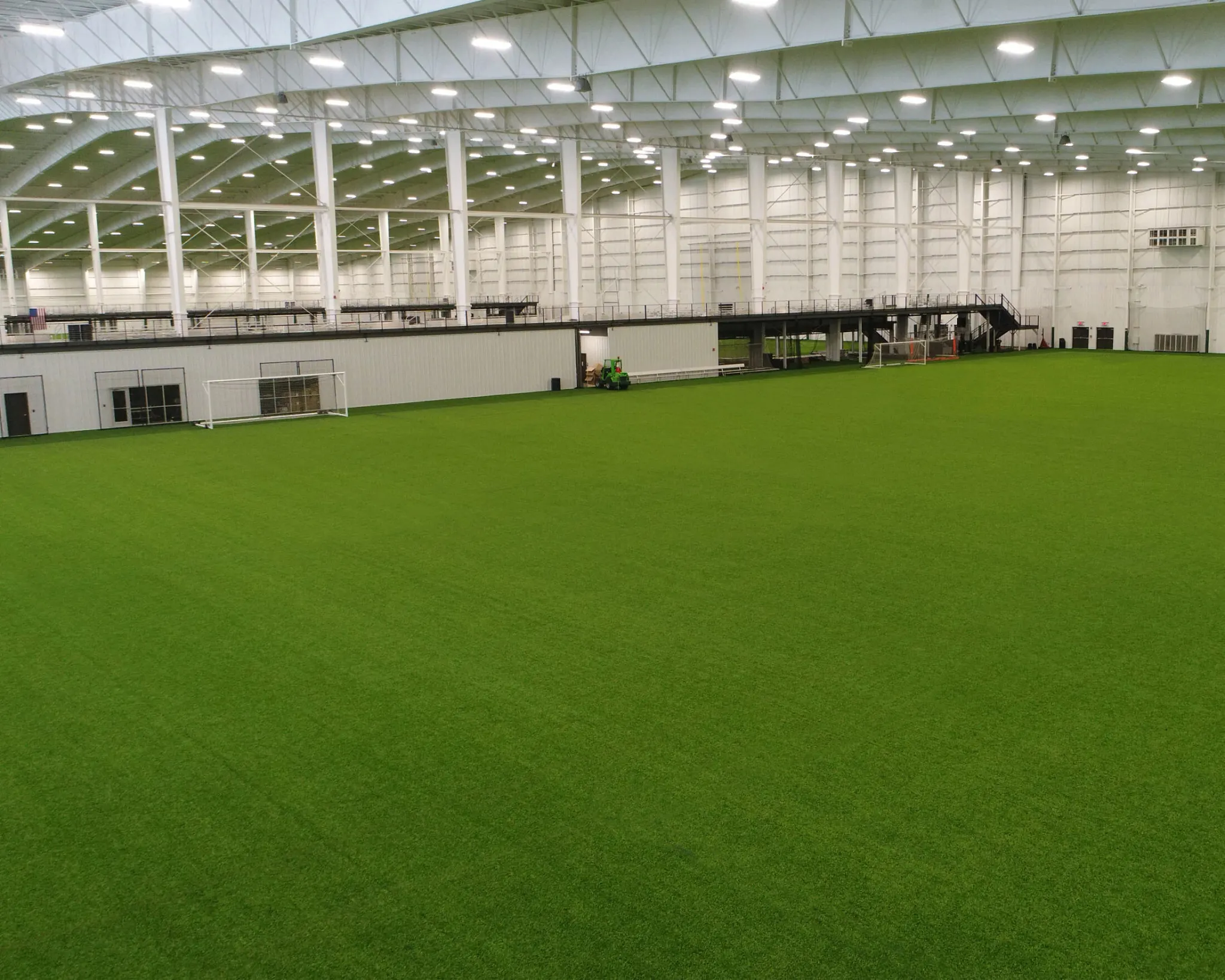 Indoor sports facility with green artificial turf