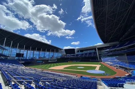 Baseball Stadium with Artificial Turf Field Baseball stadium with artificial turf field under a blue sky with clouds