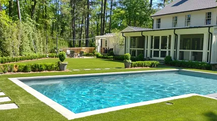Elegant outdoor space with pool and synthetic turf Backyard with swimming pool and artificial grass