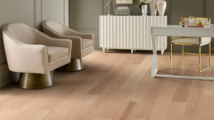Modern living room with light wood flooring and stylish decor Elegant living room with light wood flooring, featuring beige armchairs, a white sideboard, and decorative elements