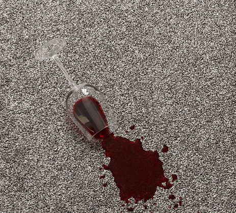 Spilled glass of wine on a neutral carpet