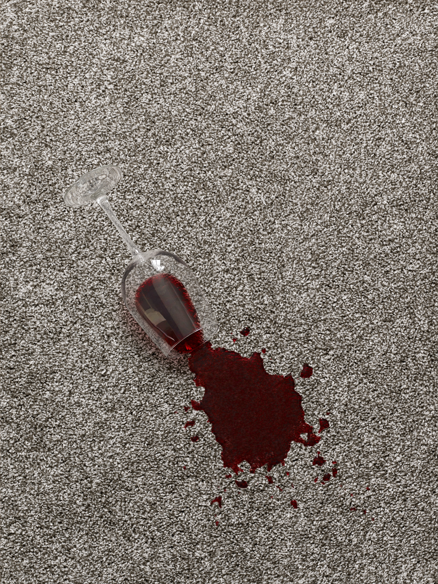 Spilled glass of wine on a neutral carpet