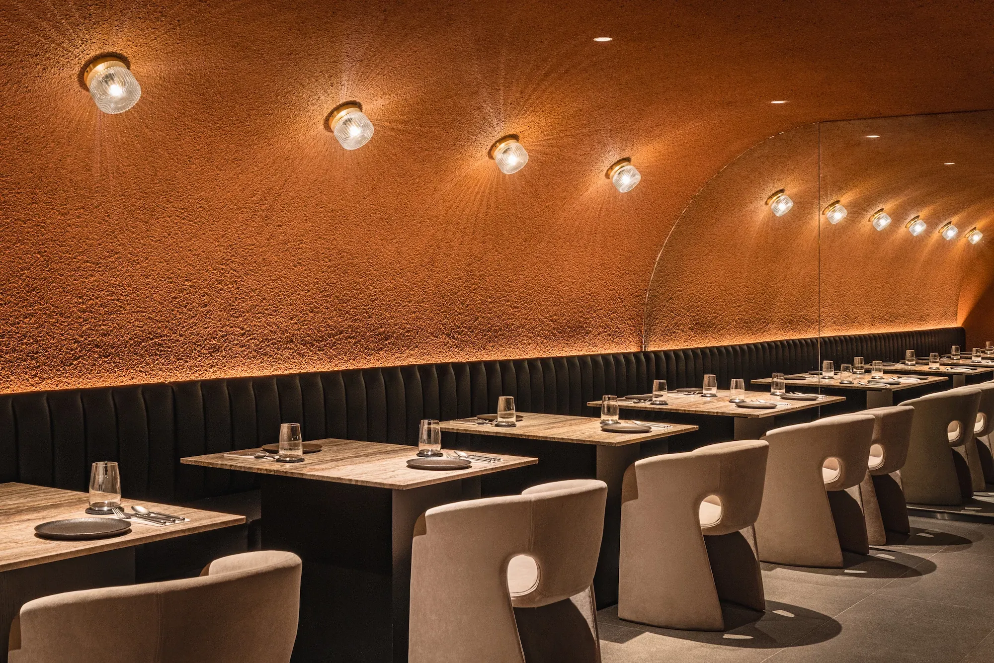 Modern restaurant interior with elegant lighting and seating, showcasing commercial flooring