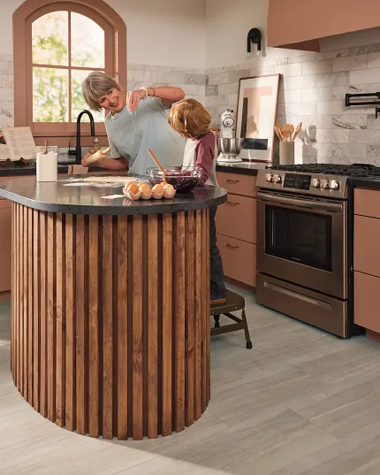 Coretec Residential WPC Stone Look Vinyl Flooring in Modern Kitchen - 24x12 inch kitchen with floor in a light stone look with a wooden island and stainless steel appliances