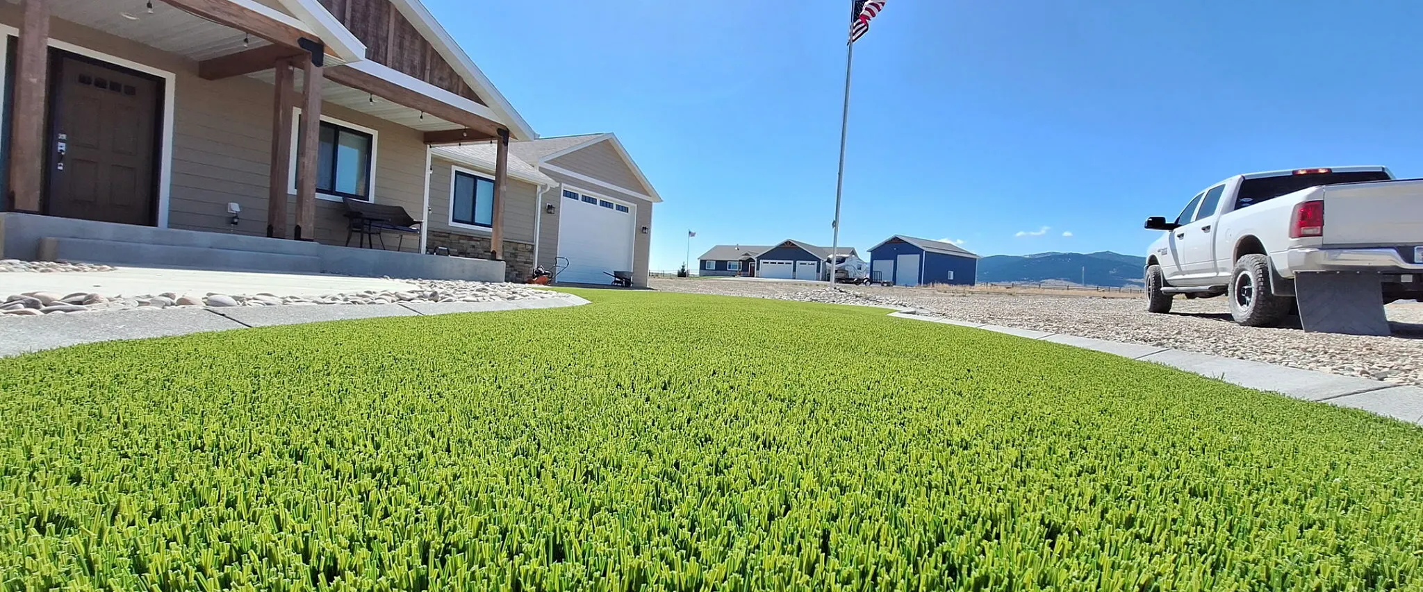 Artificial grass lawn in front of suburban homes
