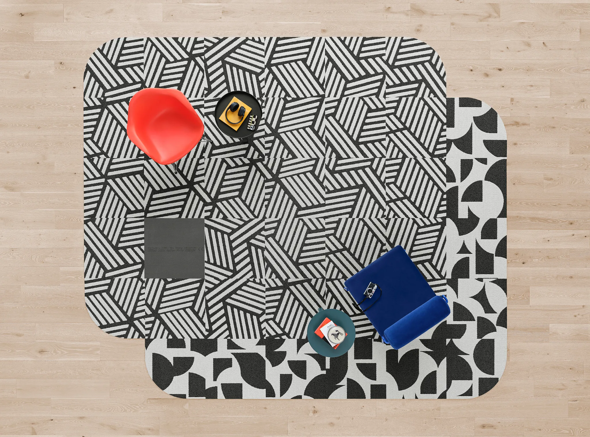 Black and white geometric carpet tiles with red and blue chairs