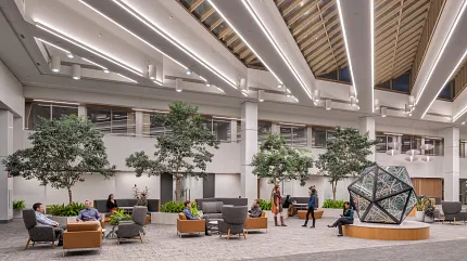 Contemporary Workplace Lobby with Commercial Carpet Flooring and Modern Design Elements Modern workplace lobby with commercial carpet flooring, featuring contemporary seating and indoor plants under a skylit ceiling