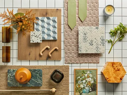 Diverse Hardwood and Carpet Flooring Samples Display Overhead view of various flooring samples including hardwood and textured carpets in beige