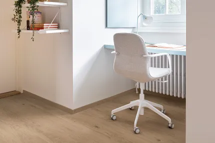 Light Oak Wood Look Luxury Vinyl Plank Flooring in Modern Home Office Modern home office with light oak wood look luxury vinyl plank flooring, white swivel chair, and minimalist decor