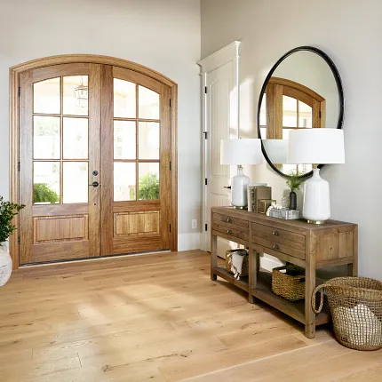 Light Hardwood Flooring in Cozy Entryway with Wooden Accents Warm and inviting entryway with light hardwood flooring, wooden console table, and decorative elements