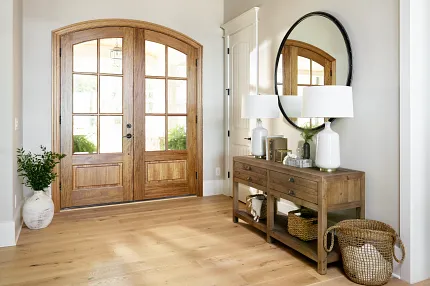 Light Hardwood Flooring in Cozy Entryway with Wooden Accents Warm and inviting entryway with light hardwood flooring, wooden console table, and decorative elements